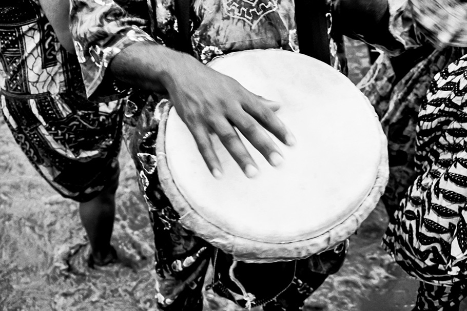 A hand playing a drum.