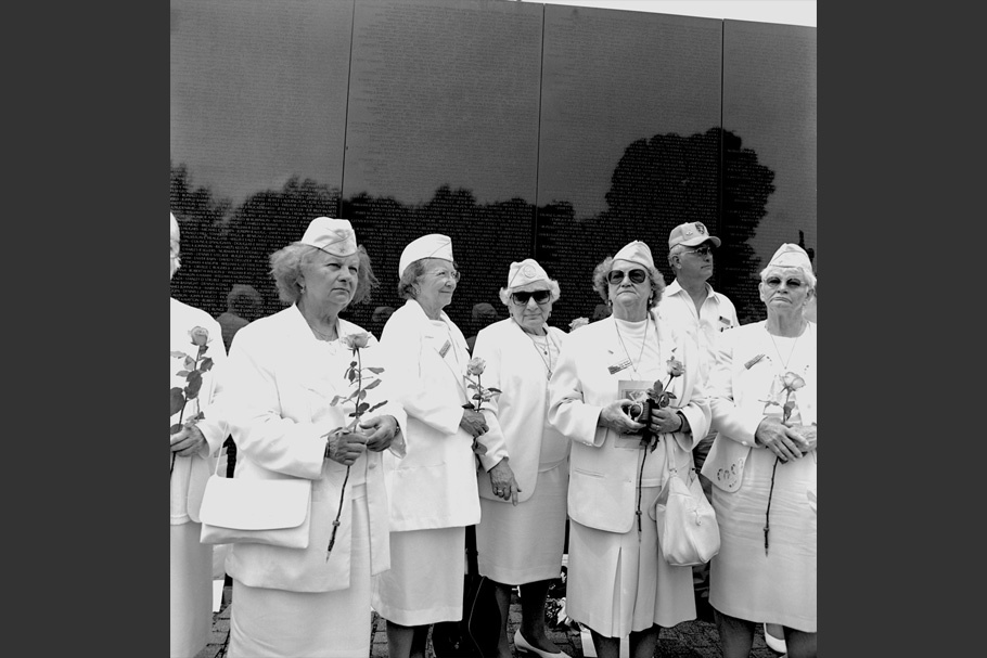 Women in uniform at the Vietnam Memorial.