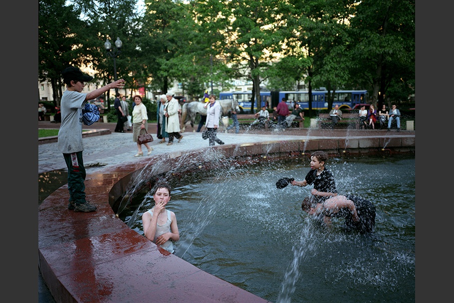 Boys playing in a fountain.