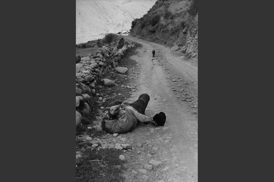 A man lying on a road.