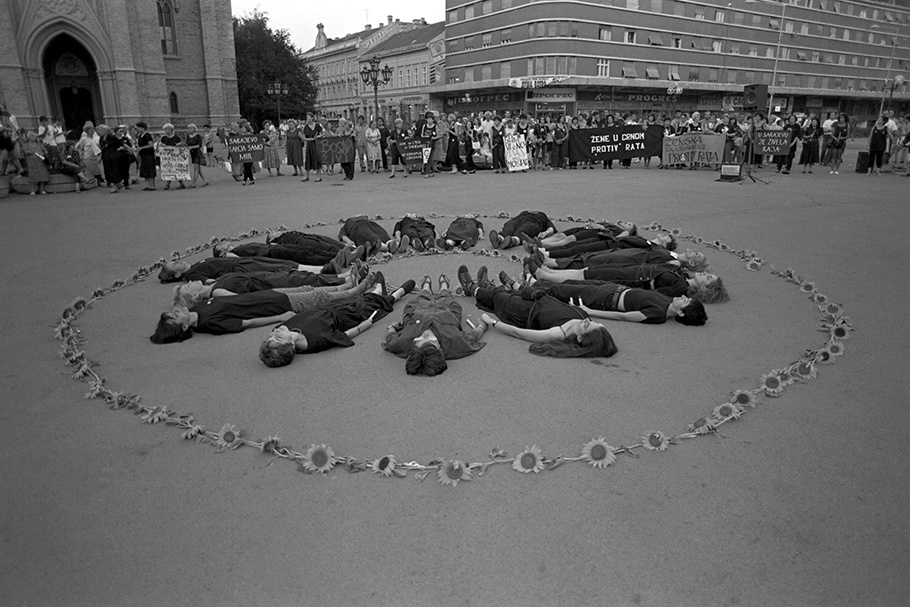 Protesters and flowers arranged in a circle.