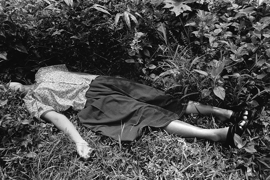 A woman lying in the grass.