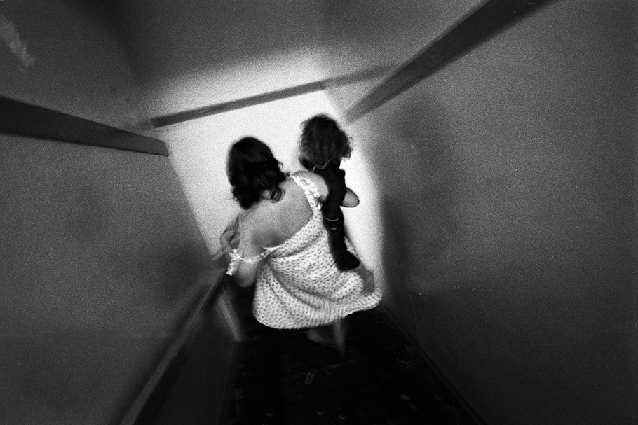 A mother and daughter walk down stairs.