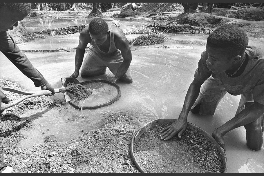 Men washing gravel in a diamond mine.