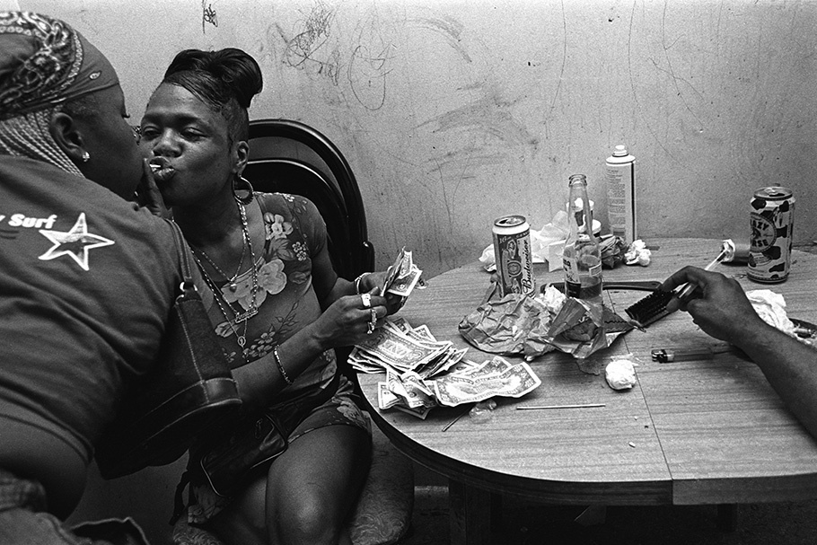 Two women at a table with cash.