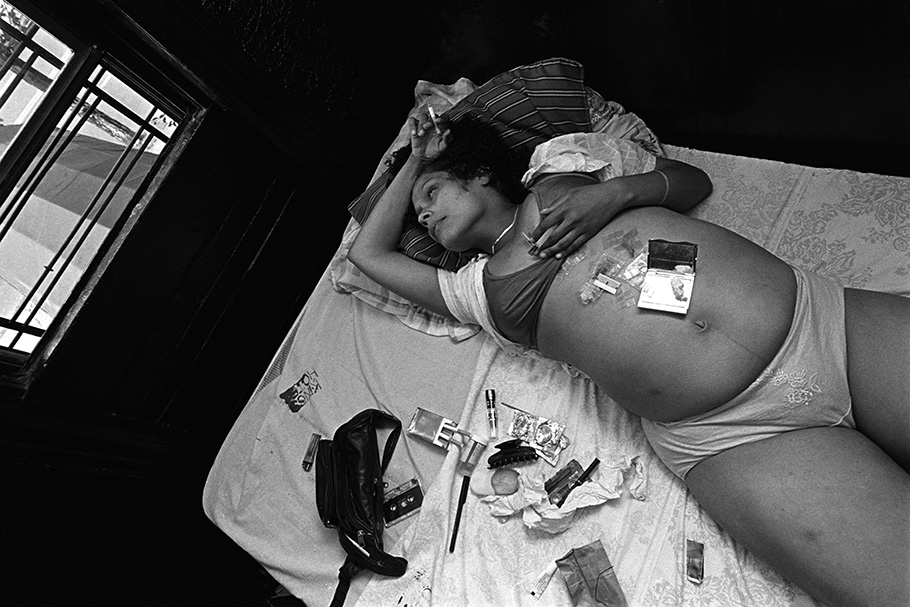 A pregnant woman lying on a bed.