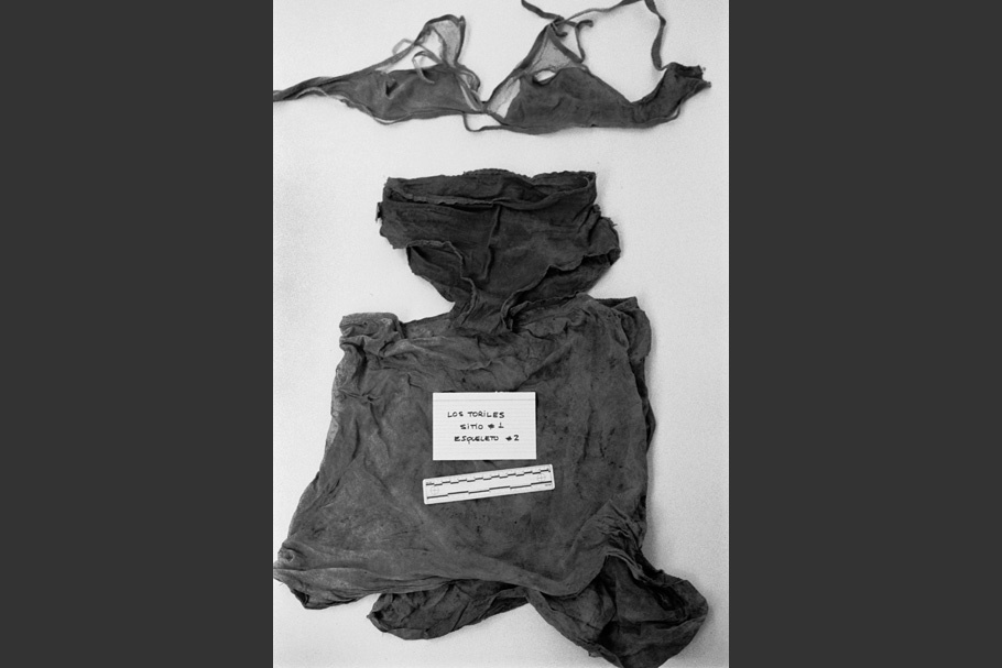 A woman’s clothing and undergarments on a table.