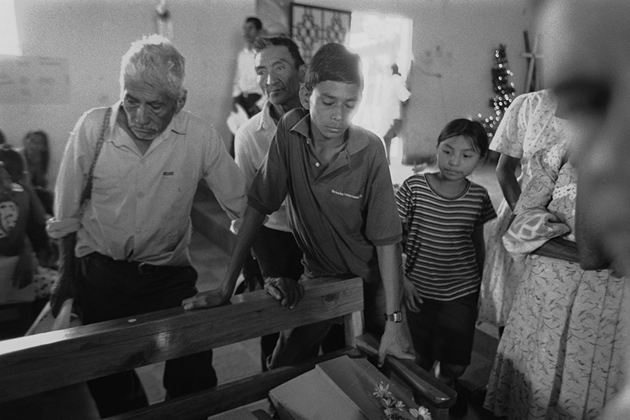 A family looking at a coffin.