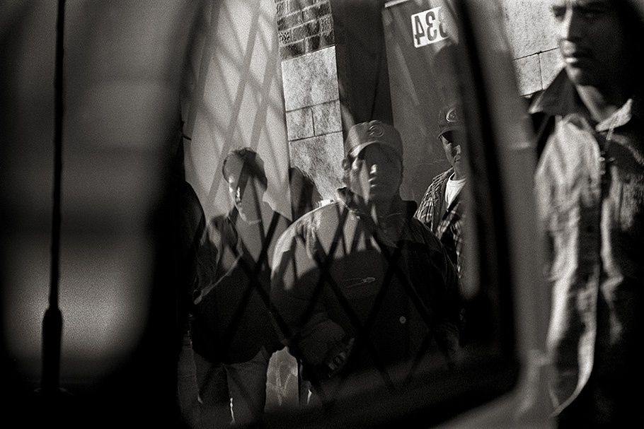 Workers viewed through a reflection.