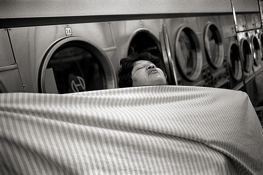 A woman in a laundromat.