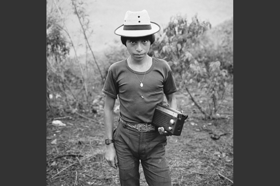 A teenage boy posing with a radio.