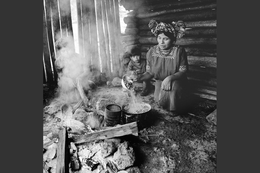 Women tending a kitchen fire.