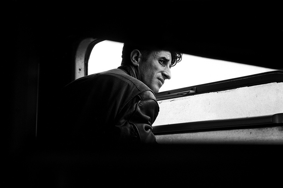 A man looks out a train window.