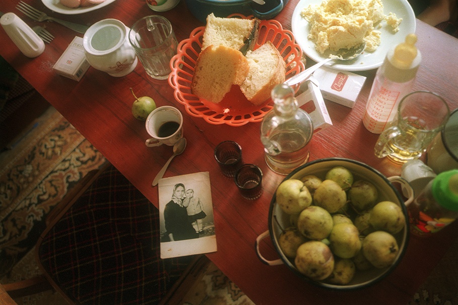 Table with food and photograph.