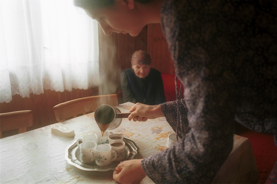 A woman pouring coffee.