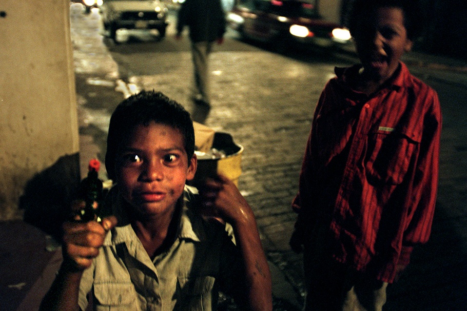 Two boys with a toy gun.