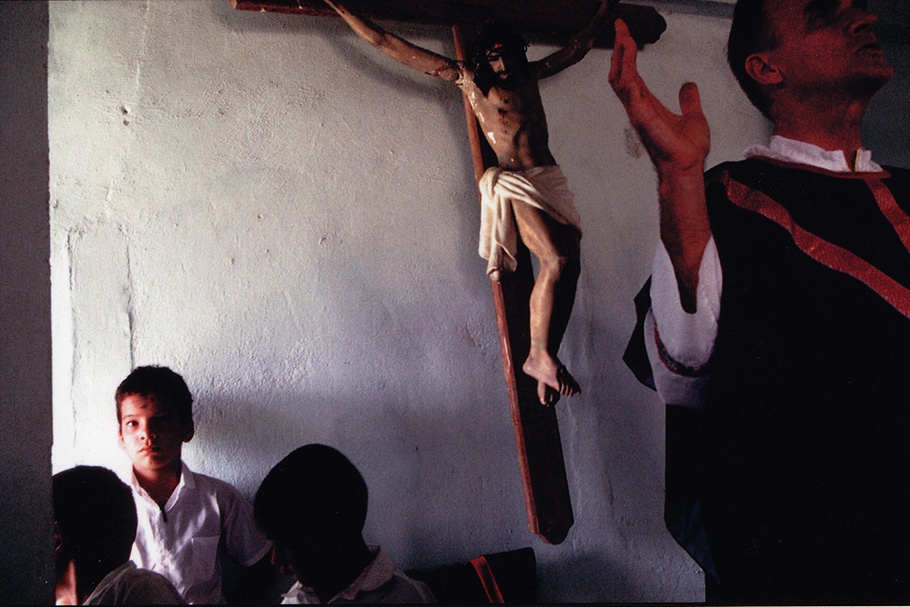 Boys under a crucifix.