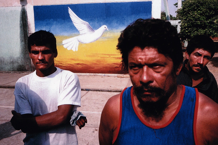 Men in front of a dove mural.