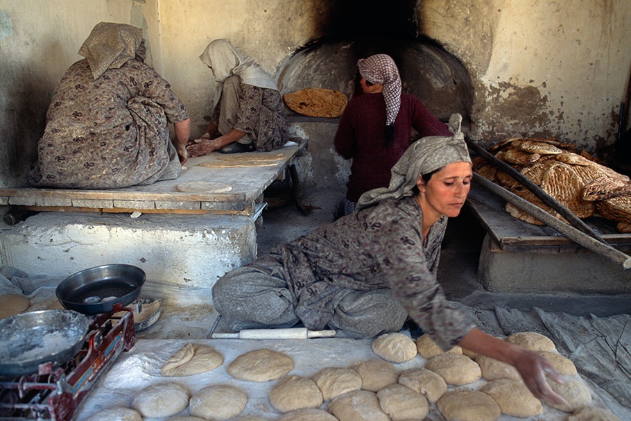 Women baking bread. 