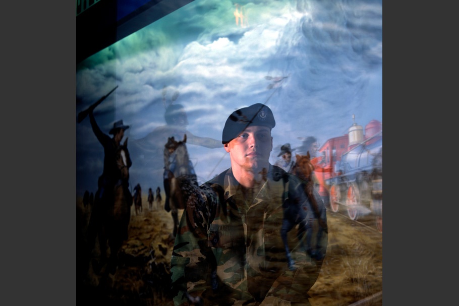 Soldier reflected in museum display glass.