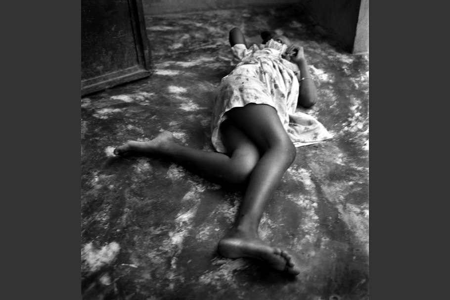 A girl lying on the ground, feet toward the camera.