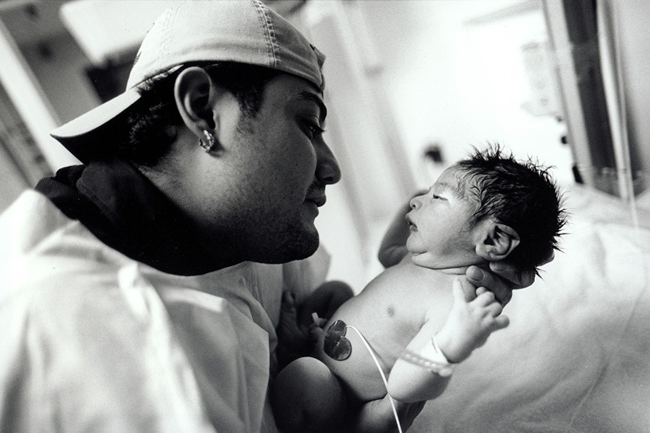 A man gazing at his newborn son.