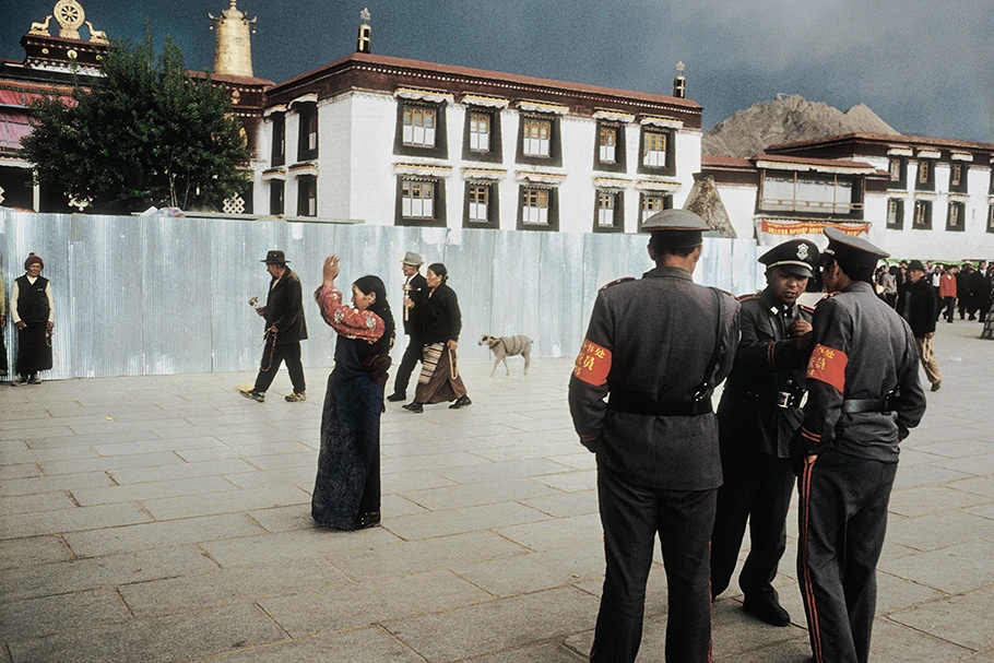 Police and pilgrims in an outdoor square.