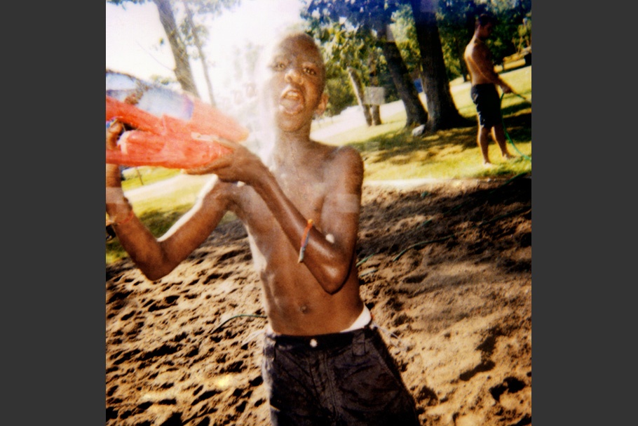 Boy playing with a water gun.