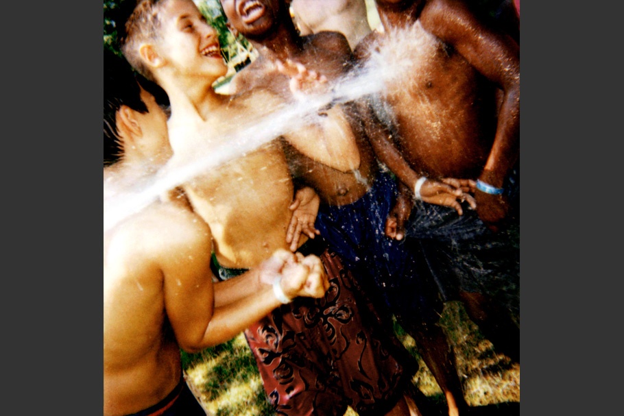 Four boys playing in water.