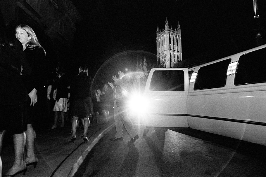 A group of teenagers outside of a limousine near the Cathedral.