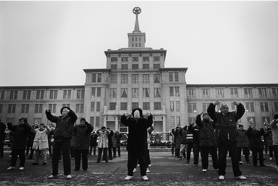 A group practicing Falun Gong outside of a building.