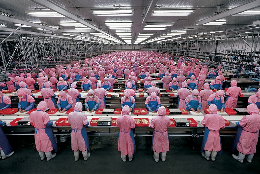 Factory workers in pink uniforms.