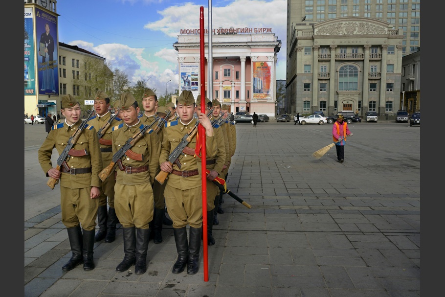 Soldiers standing in formation in a city square.