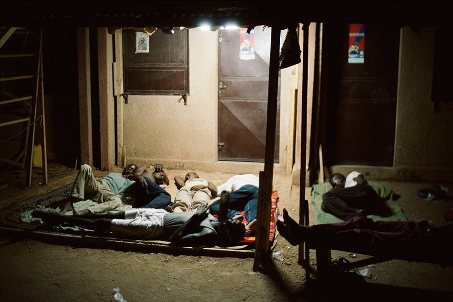 A group of men sleeping on the floor.