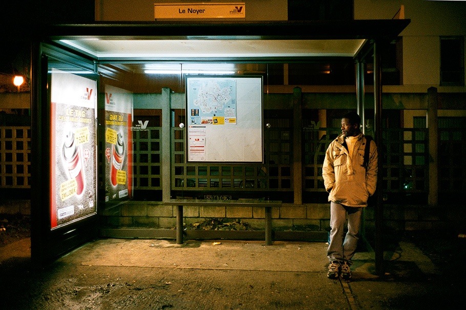 Man waiting at a bus shelter.