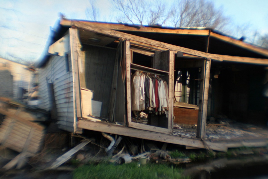 Clothes hanging in closet of destroyed home.