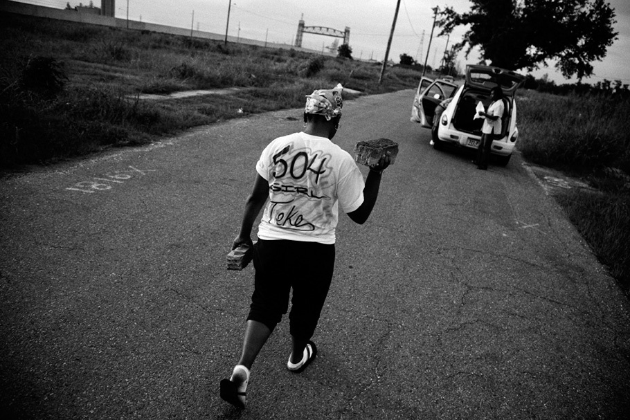 Woman walking down street with T-shirt with “504” on back.