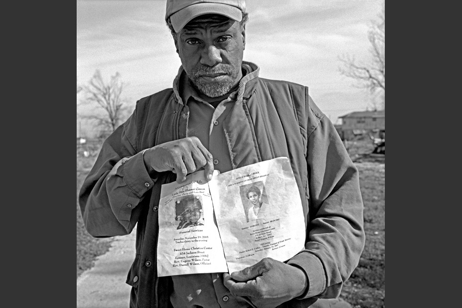 Man holding papers in front of him.