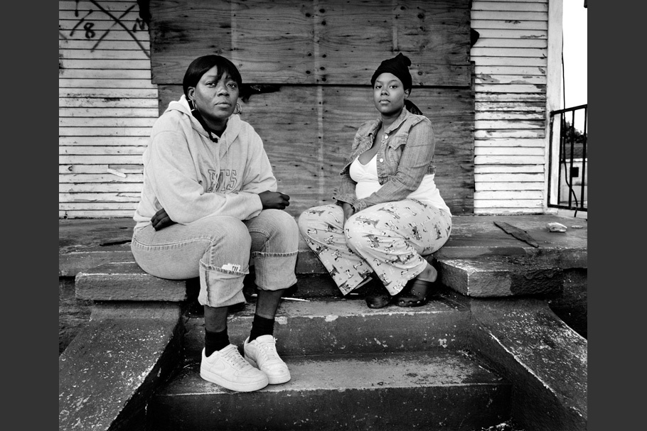 Two women sitting on steps.