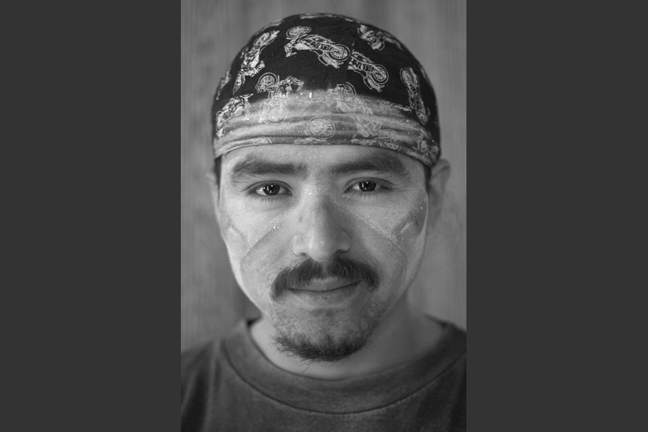 Man wearing bandana, with dust on face.
