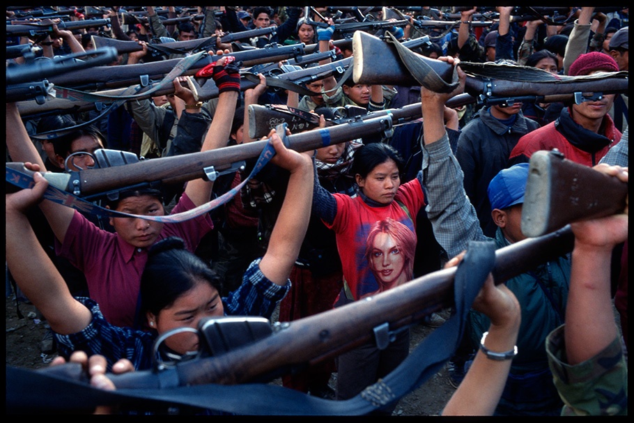 Group holding guns over their heads.
