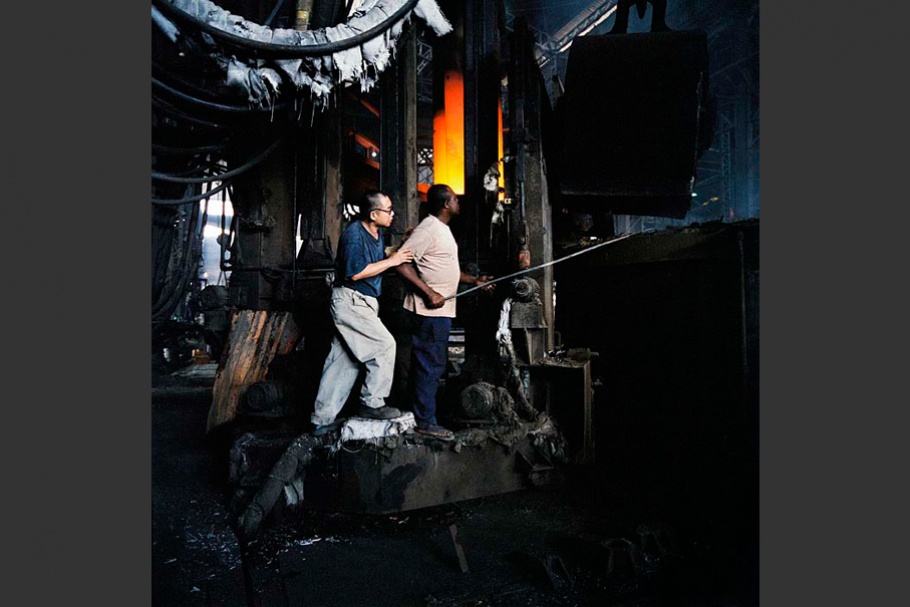 Two men working in factory setting.