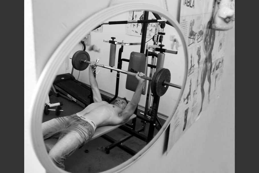 Weight lifting seen through mirror.