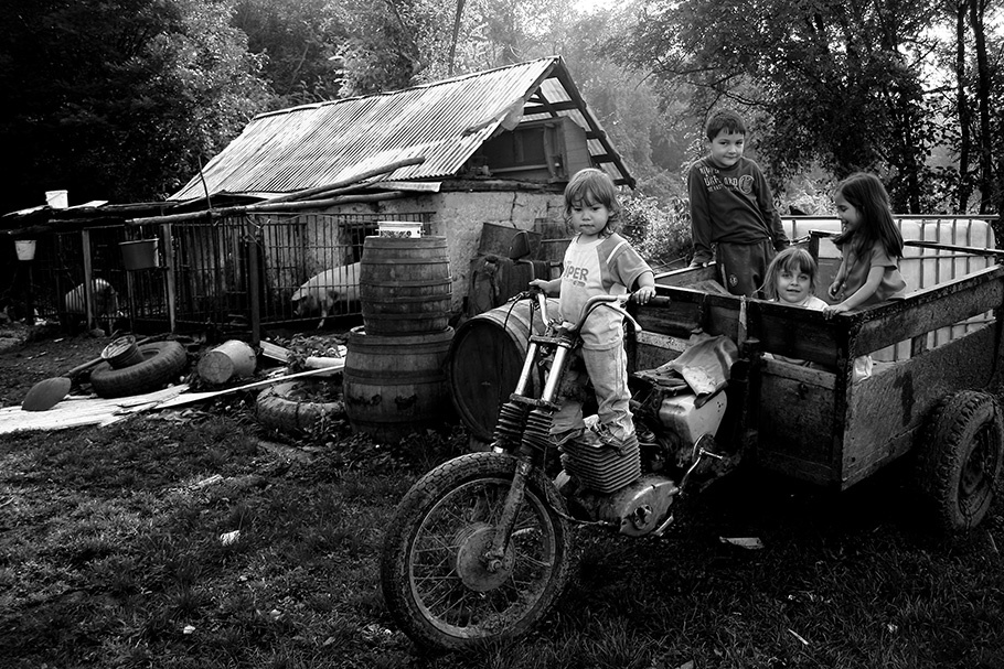 Children, farmhouse, motorcycle/tractor.