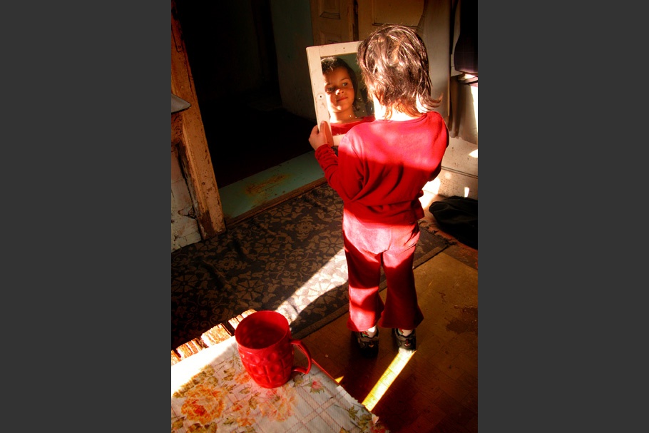 Woman in red looking at mirror