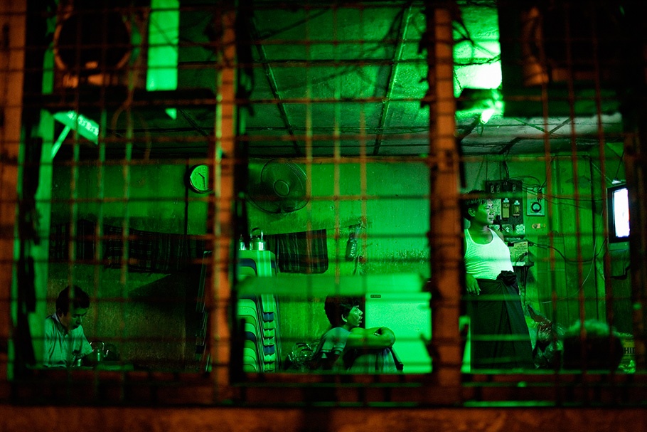 People viewed through a window. Green lighting.