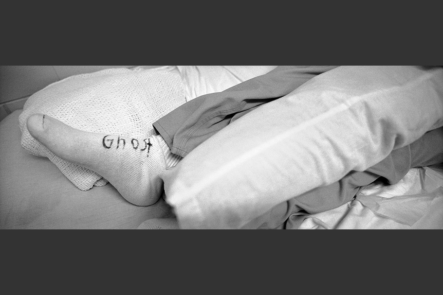 Close up of foot with sock labeled “Ghost”.