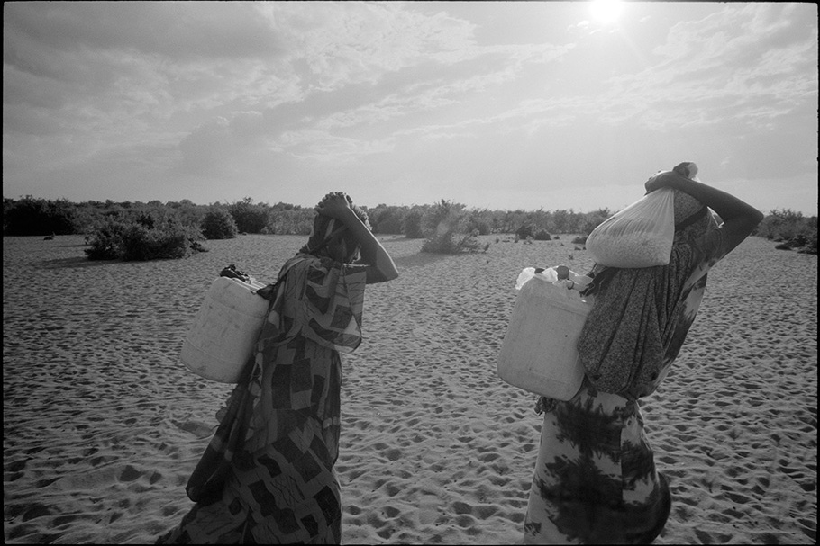 Women carrying supplies on their backs.