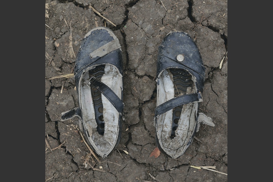 A pair of worn girl shoes.