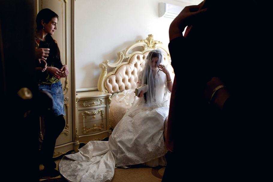 A bride sitting on a bed